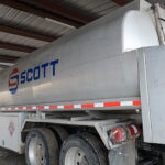 Unpolished aluminum tanker trailer before polishing with visible oxidation and dull surface finish