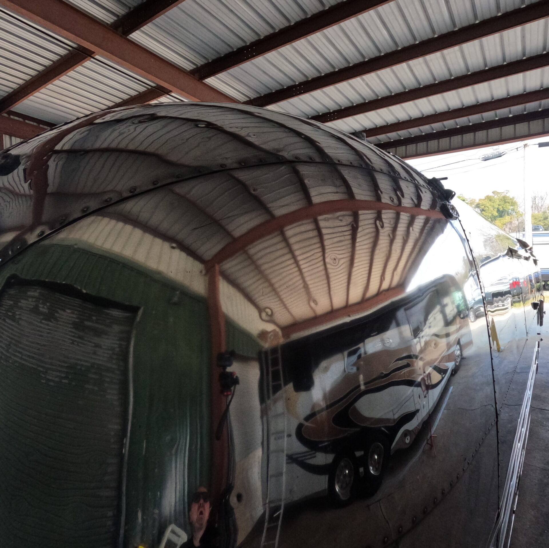 Close-up of polished Airstream showing detailed, sharp reflections.