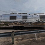 Close-up of polished Airstream showing detailed, sharp reflections.