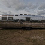 Close-up of polished Airstream showing detailed, sharp reflections.